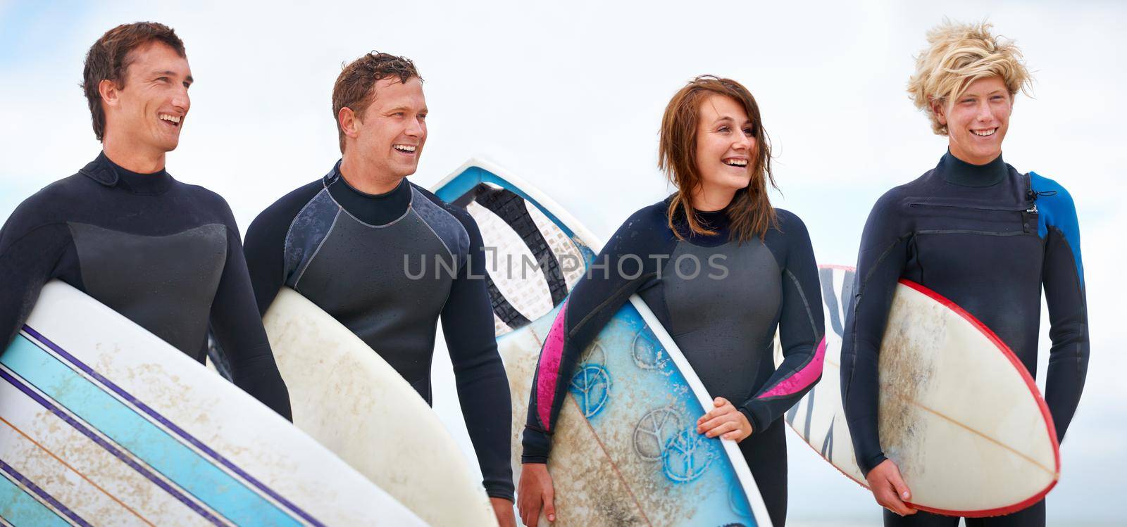 Young surfers enjoying a day out on the beach in the summertime.