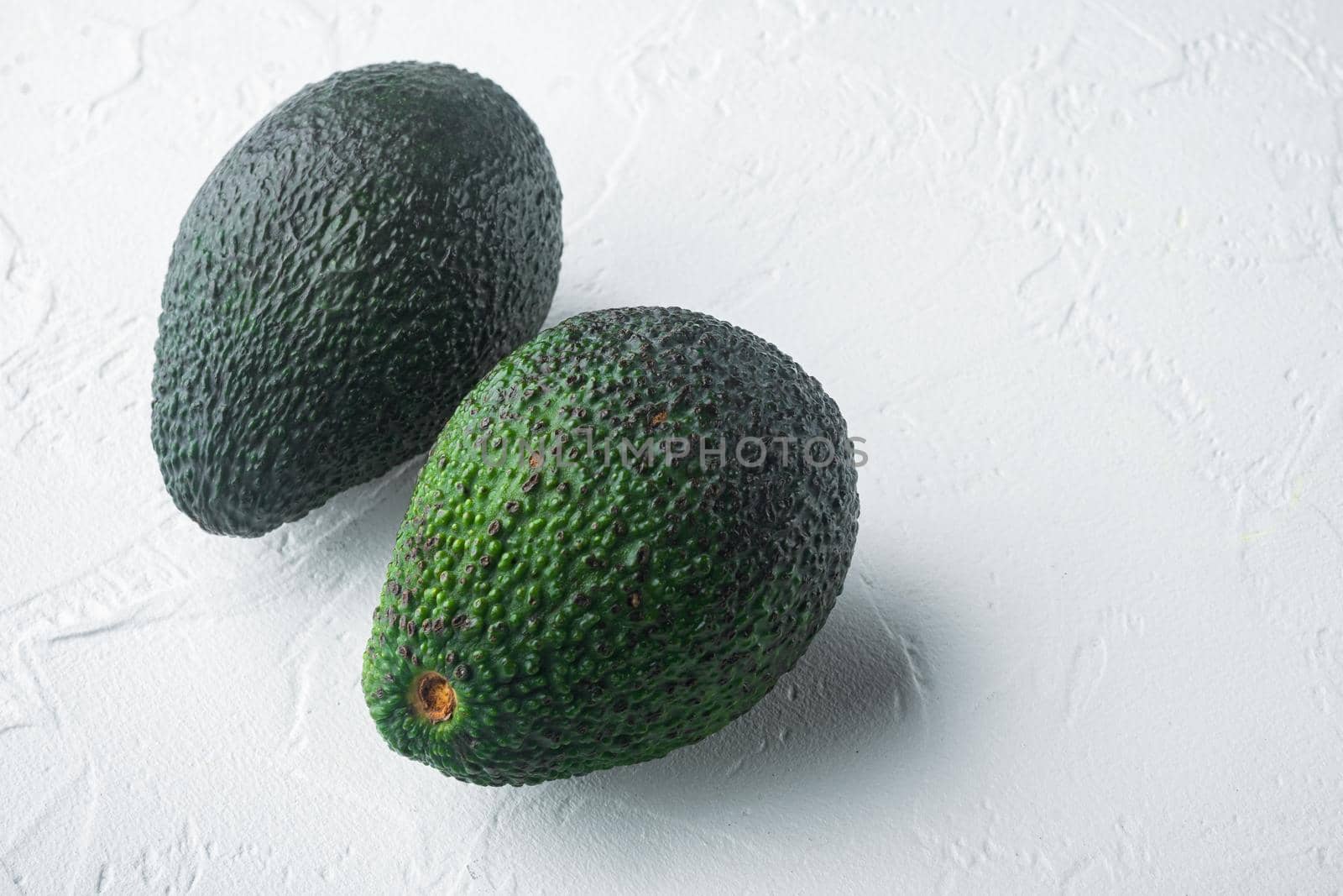 Whole pair of green avocado, on white background with copy space for text by Ilianesolenyi