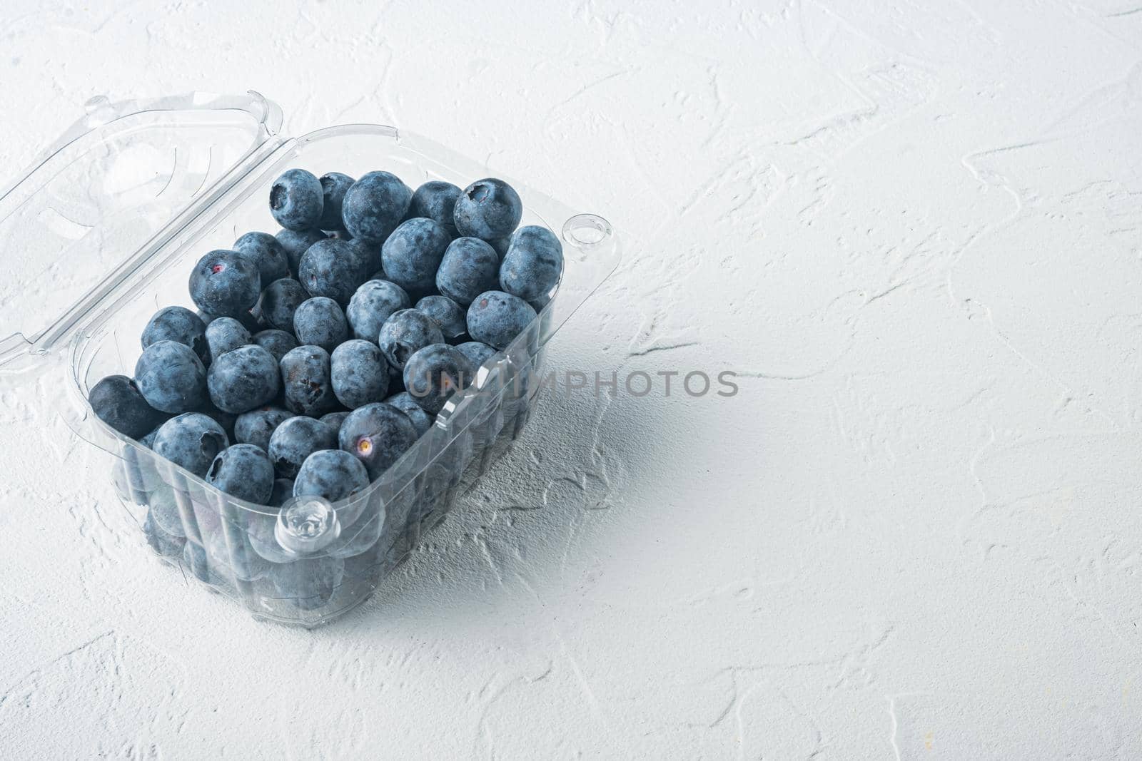 Quarts of blueberries, on white background with copy space for text by Ilianesolenyi