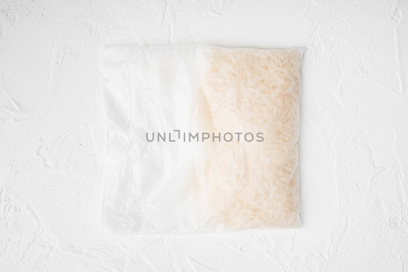 Quick cooking rice bag, on white stone table background, top view flat lay by Ilianesolenyi