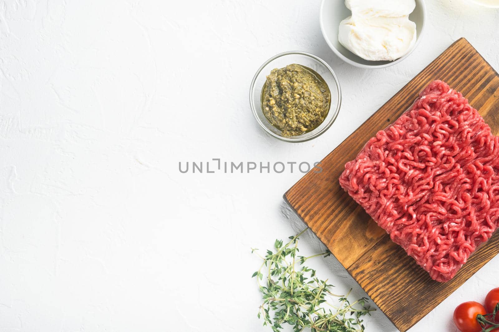 Raw meatballs made from ground beef ingredients set, on white stone background, top view flat lay, with copy space for text