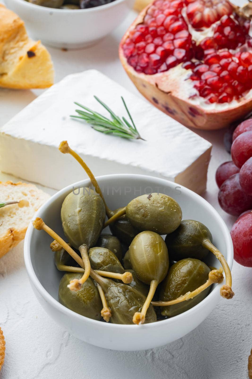 Organic pickled canned capers, on white background by Ilianesolenyi