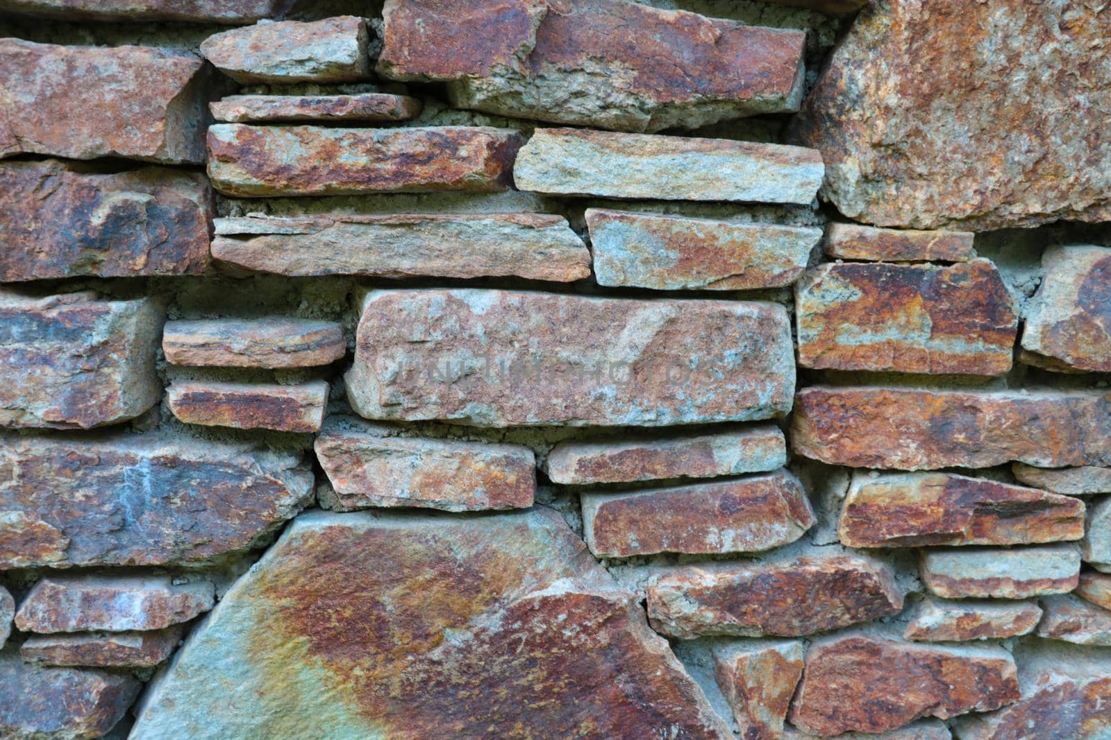 The texture of the stone wall of the building or structure, the background of the stone