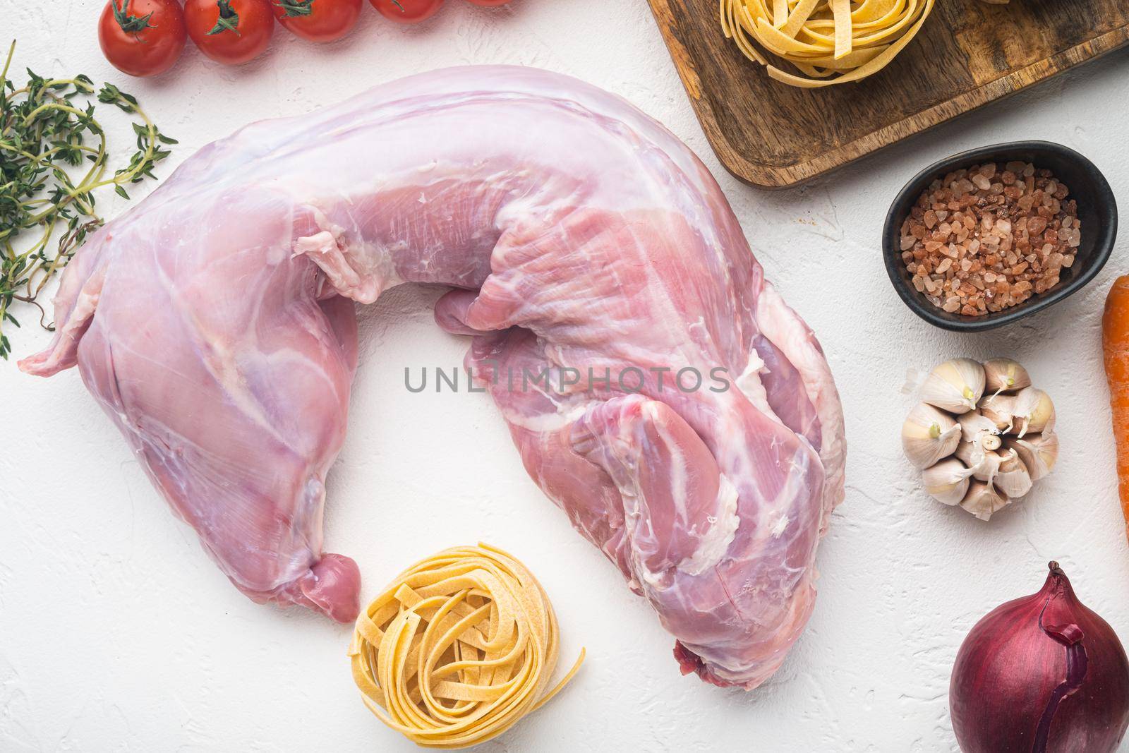 Fresh meat. Whole rabbit ready to cook stew tagliatelle set, on white stone background, top view flat lay