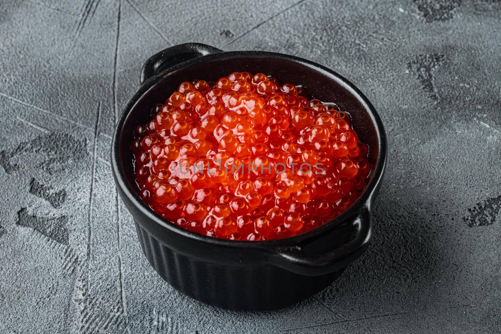 Red caviar bowl, on gray background by Ilianesolenyi