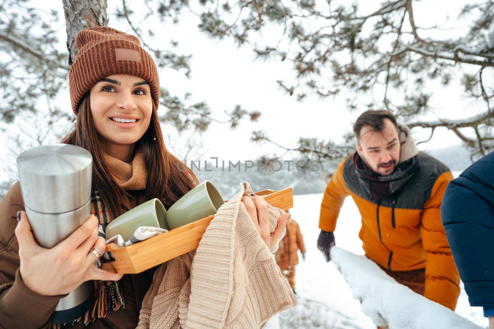 Young woman taking luggage out of car on winter trip, close up