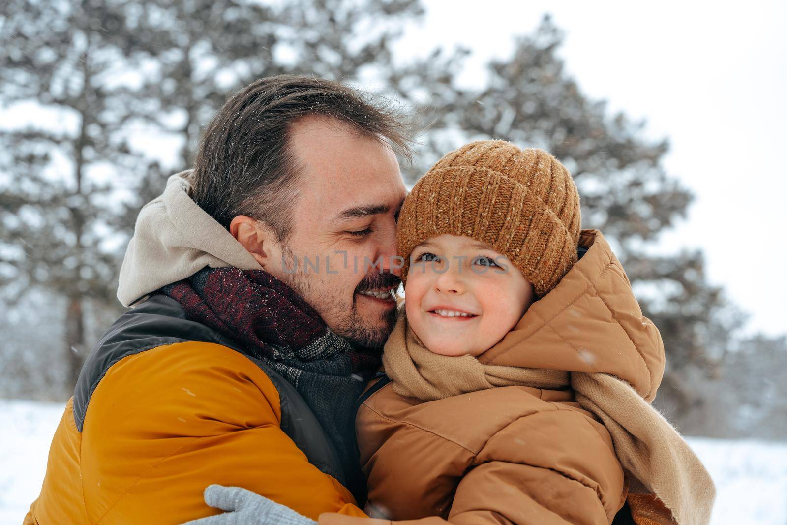 Father and son playing in the park on winter day by Fabrikasimf
