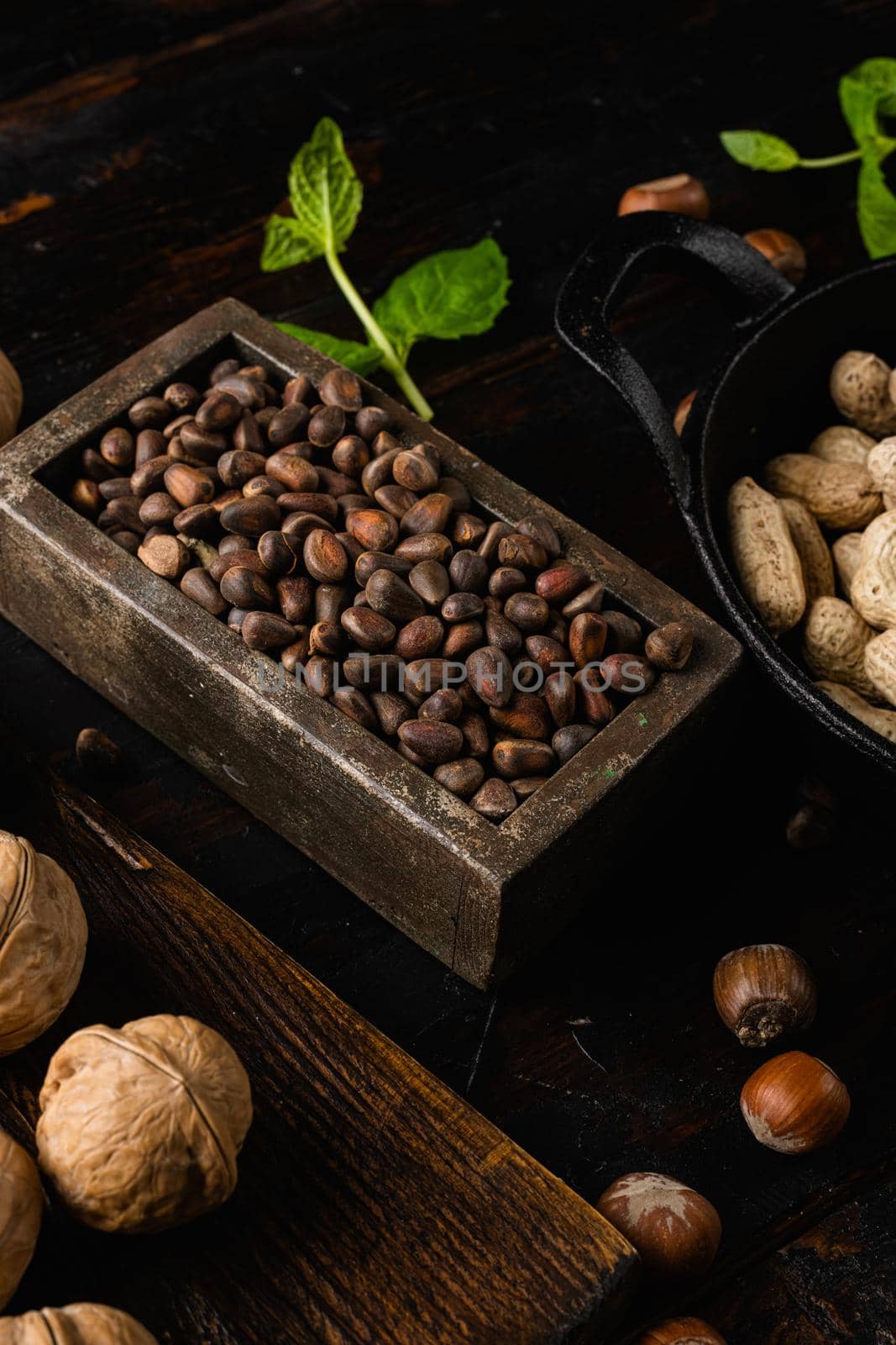 Cedar wild organic nut set, on old dark wooden table background