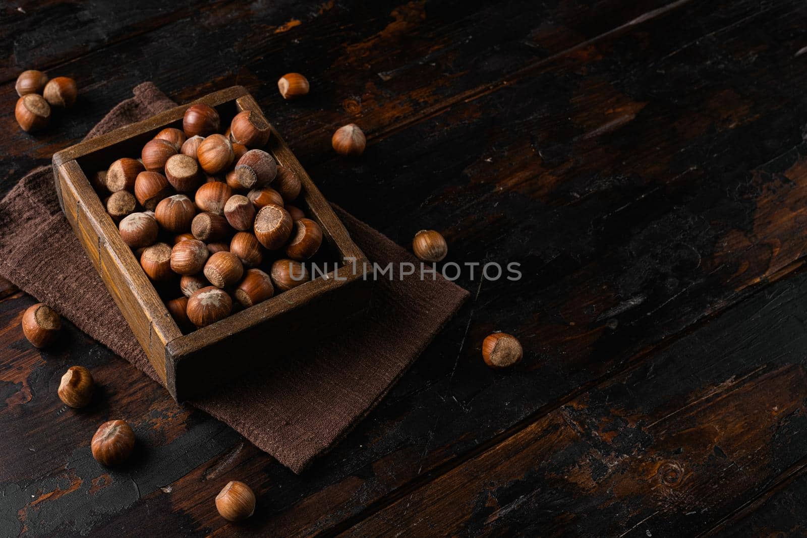 Hazelnut nut health organic brown filbert set, on old dark wooden table background, with copy space for text