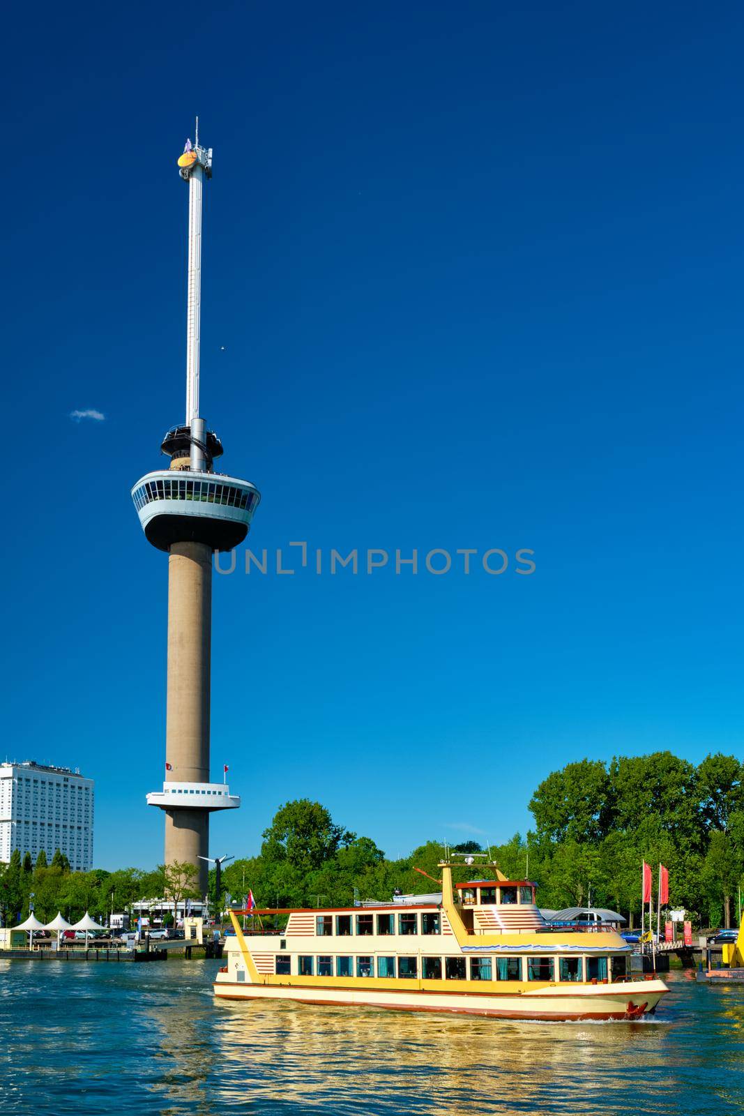 Rotterdam cityscape with Euromast observation tower and tourist boat on Nieuwe Maas river. Rotterdam, Netherlands