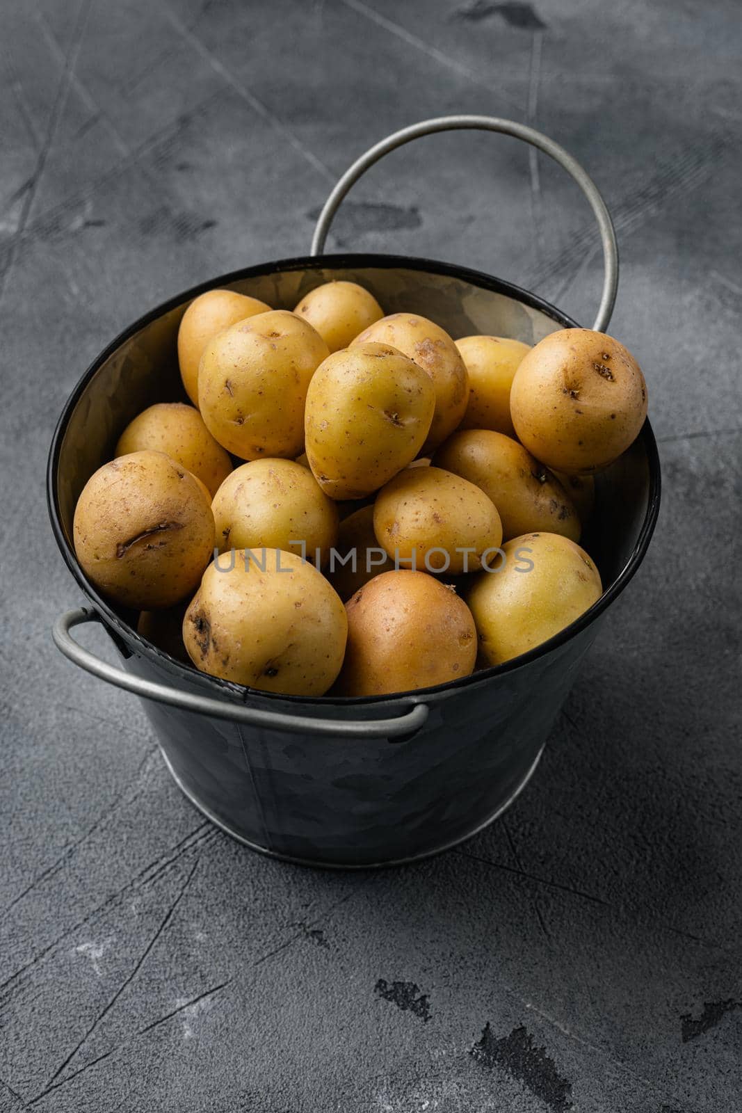 Organic White Baby Potatoes, on gray stone table background, with copy space for text by Ilianesolenyi