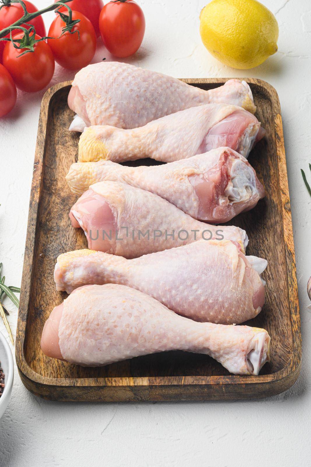 Organic chicken legs with spices and garlic set, on white background