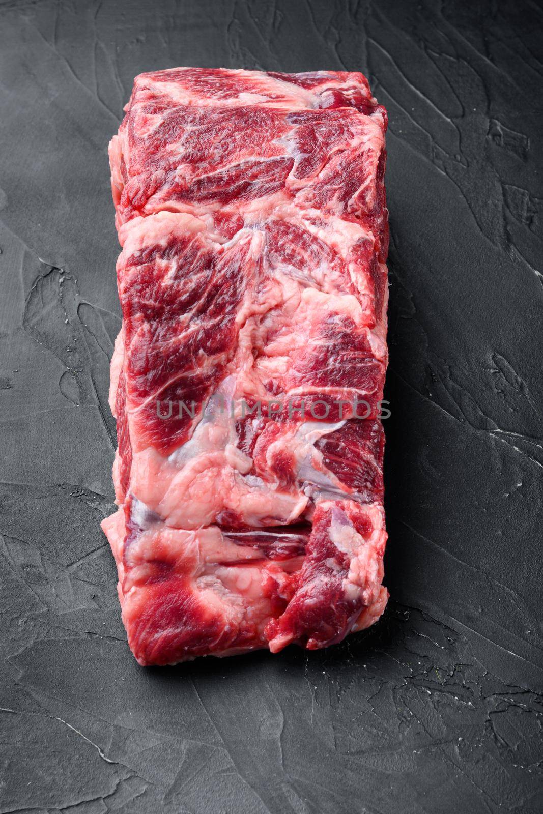 Rib eye beef meat cut raw set, on black stone background, top view flat lay