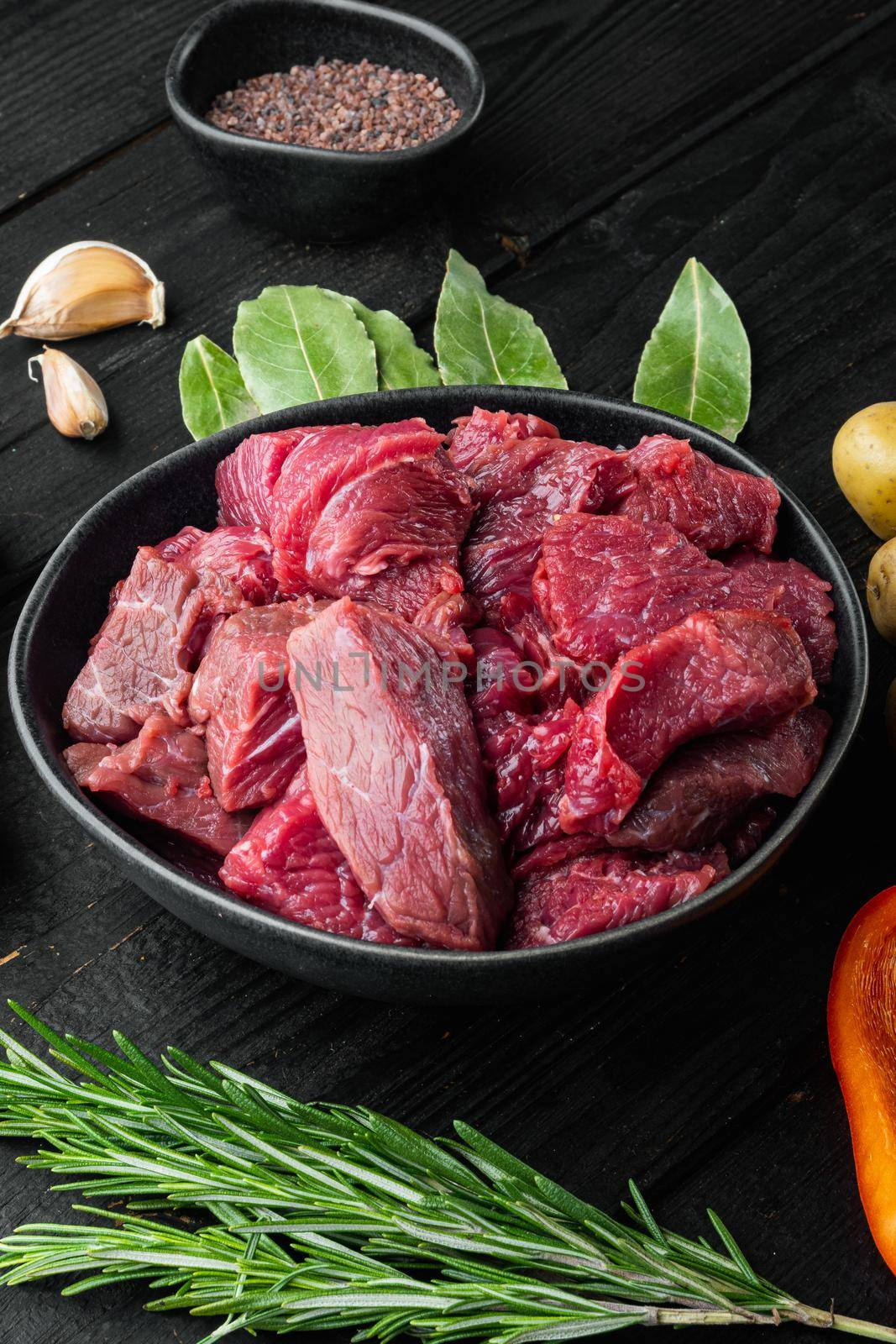 Fresh raw chopped beef set, on black wooden background