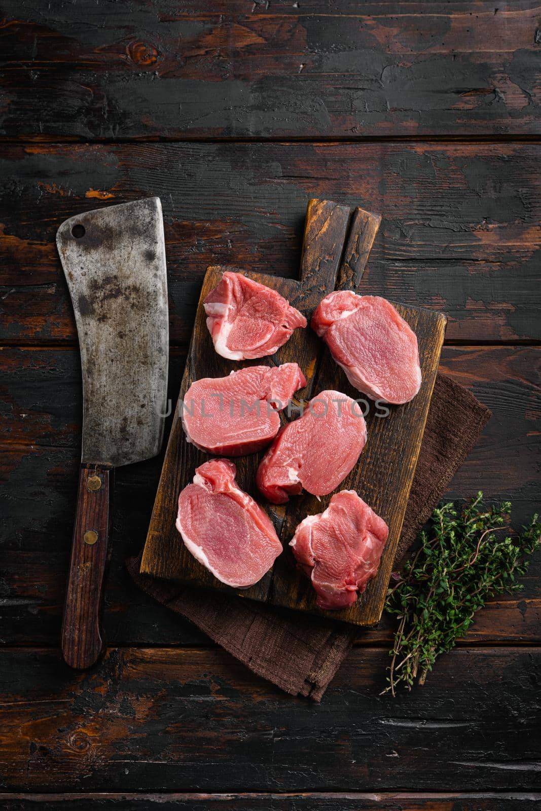 Pork tenderloin. Fresh raw meat prepared for cooking set, on old dark wooden table background, top view flat lay by Ilianesolenyi