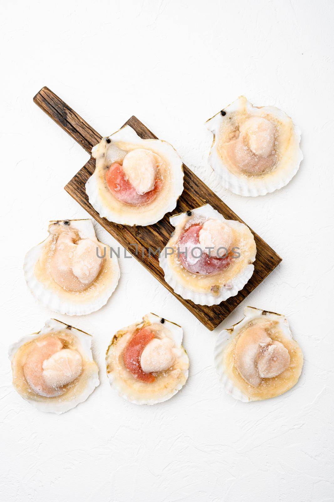 Frozen sea Scallops, on white stone table background, top view flat lay, with copy space for text by Ilianesolenyi
