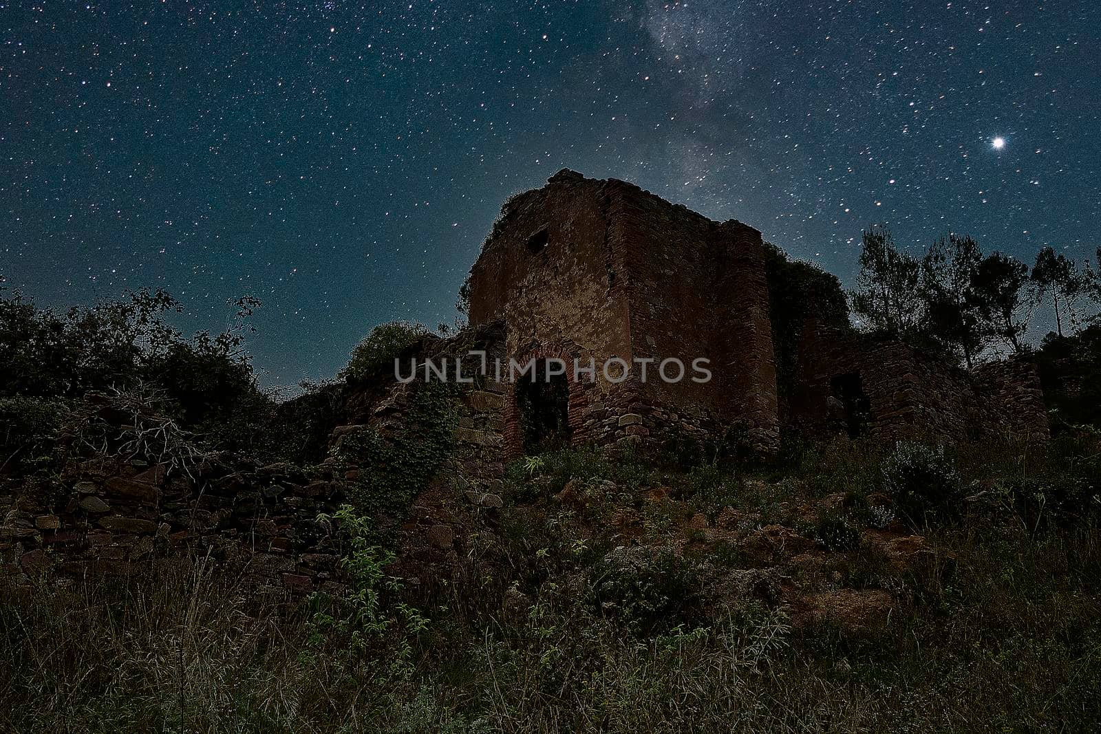 Jinquer, Castellon, Spain.tarry sky and Milky Way over an abandoned and destroyed church on top of a mountain. Solitaire, horror, fear, Spanish Civil War, texture, vegetation