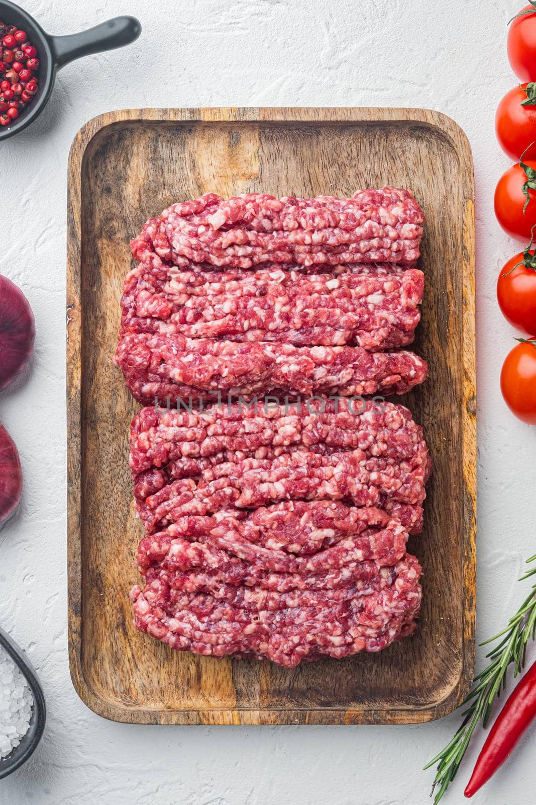 Raw minced fresh meat, on white background, top view flat lay