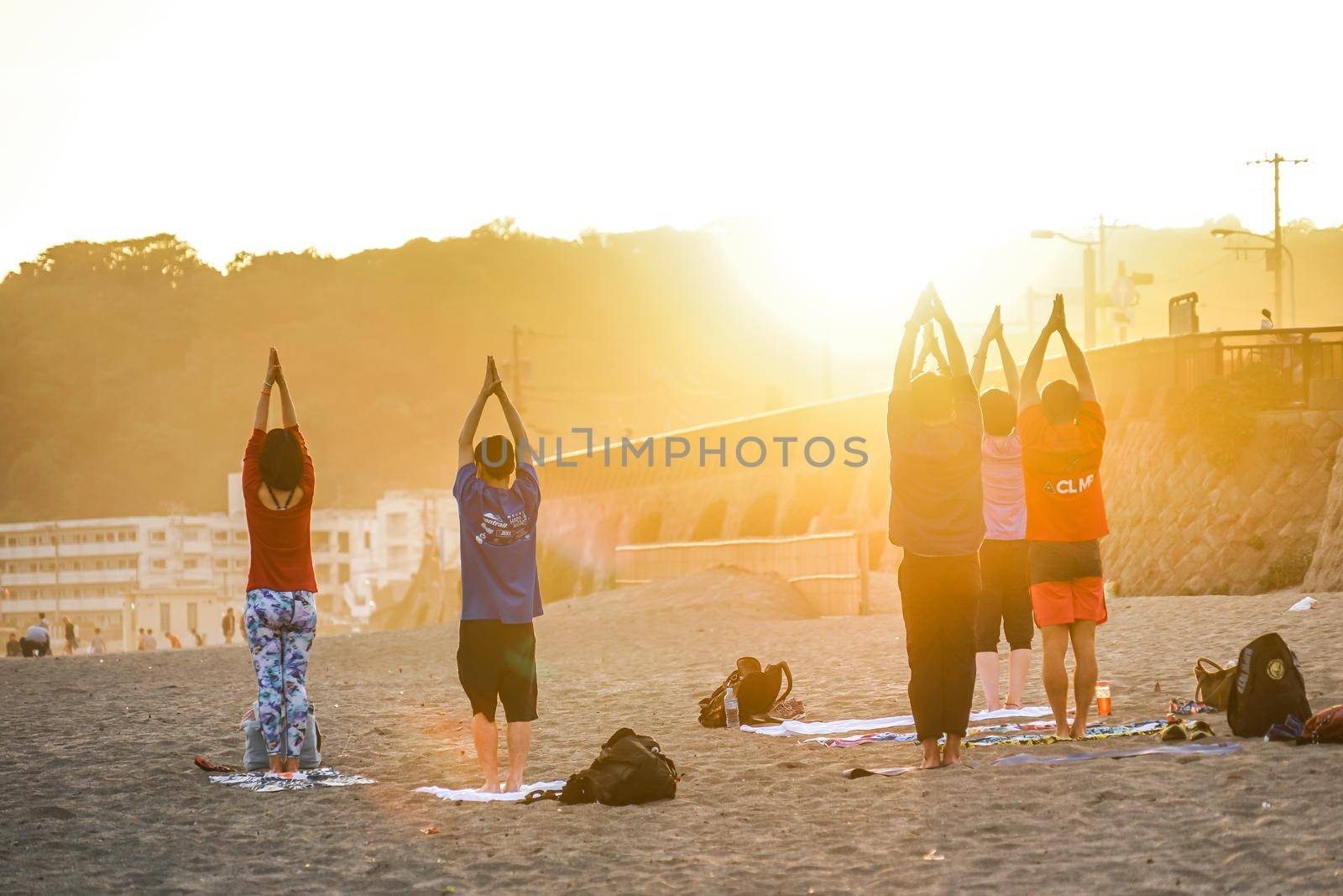 Sunset sandy beach and yoga. Shooting Location: Kamakura City, Kanagawa Prefecture