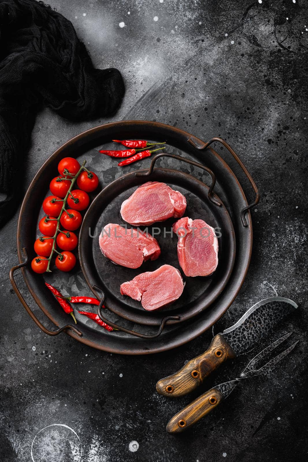 Raw pork fillet set, on black dark stone table background, top view flat lay by Ilianesolenyi