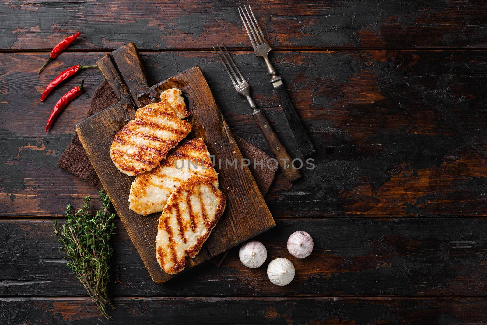 Ready to eat chicken schnitzel set, on old dark wooden table background, top view flat lay, with copy space for text by Ilianesolenyi