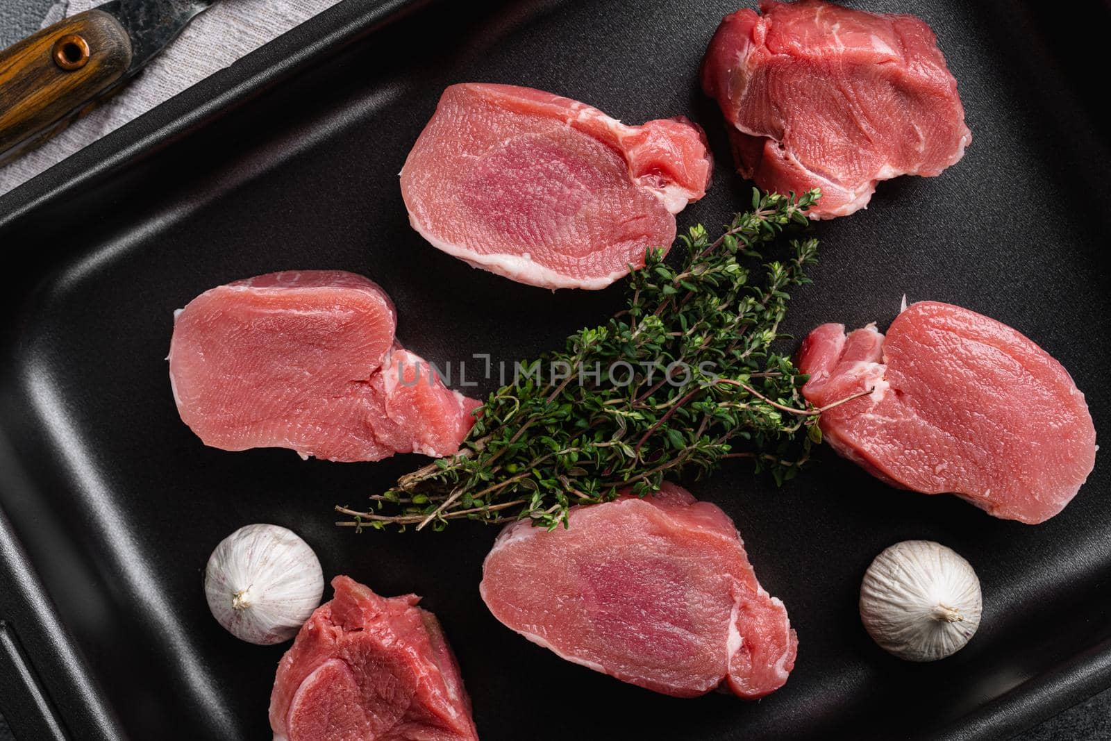 Organic pork meat chops set, on gray stone table background, top view flat lay by Ilianesolenyi