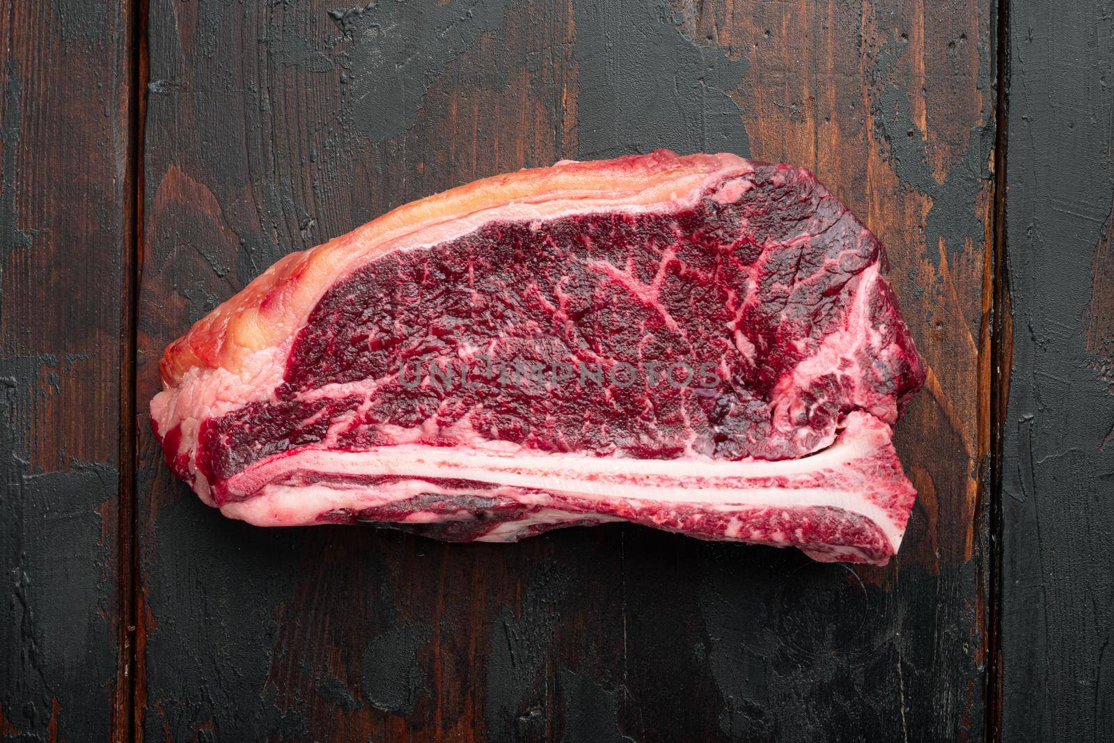 Raw fresh meat dry aged Club Steak set, on old dark wooden table background, top view flat lay