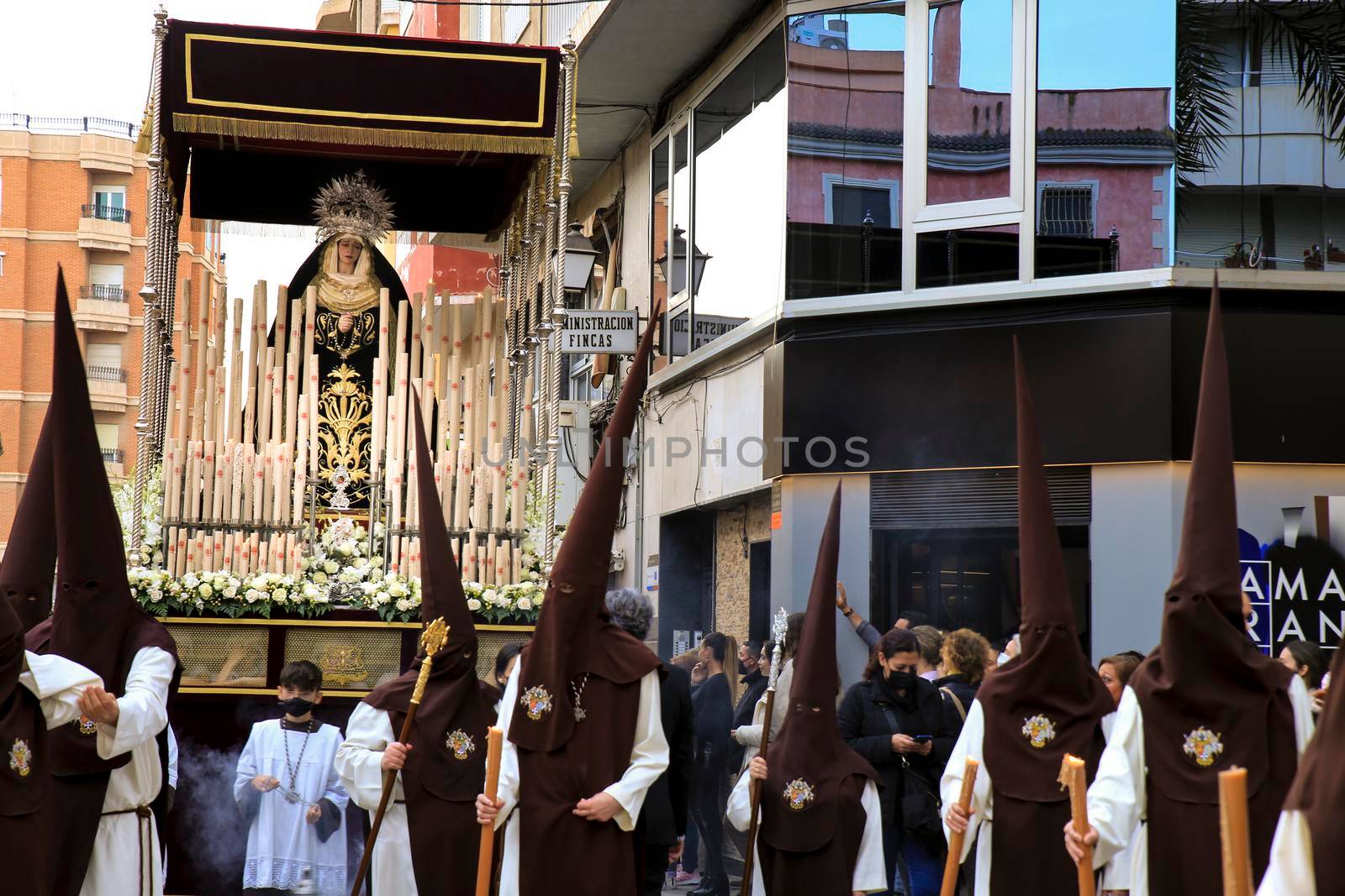 Elche, Spain- April 13, 2022: Virgin Mary on Easter Parade with bearers and penitents through the streets of Elche city in the Holy Week