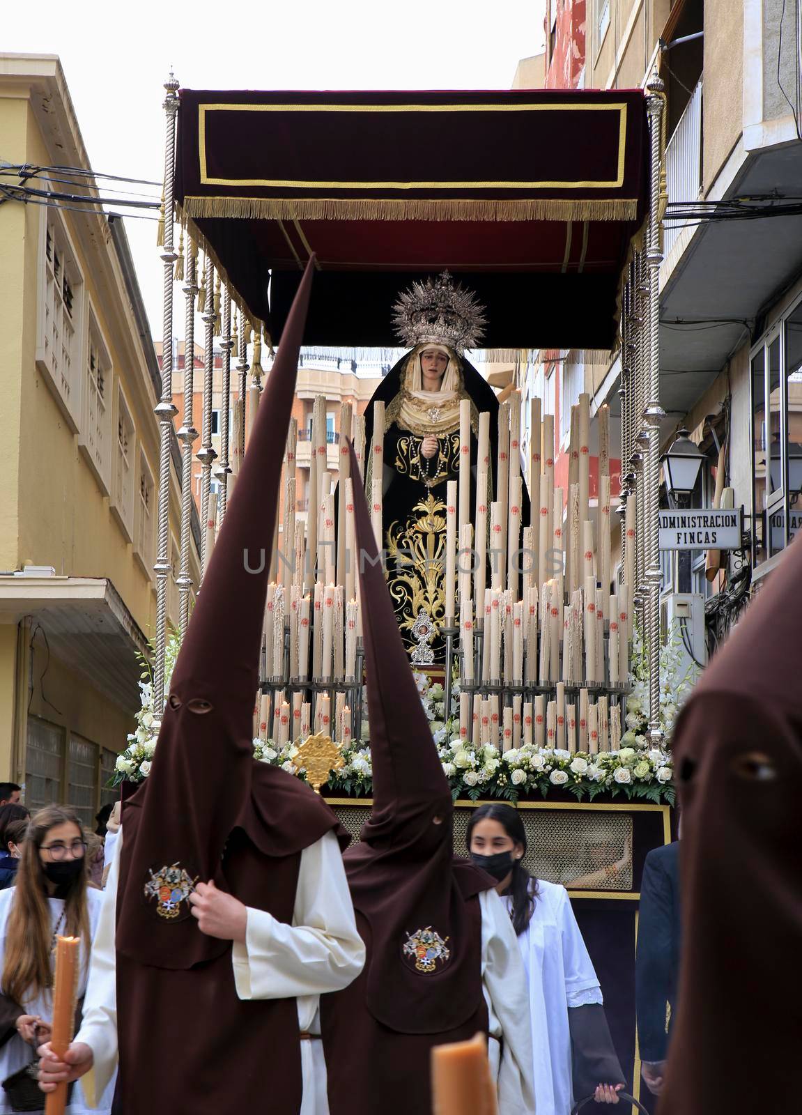 Elche, Spain- April 13, 2022: Virgin Mary on Easter Parade with bearers and penitents through the streets of Elche city in the Holy Week