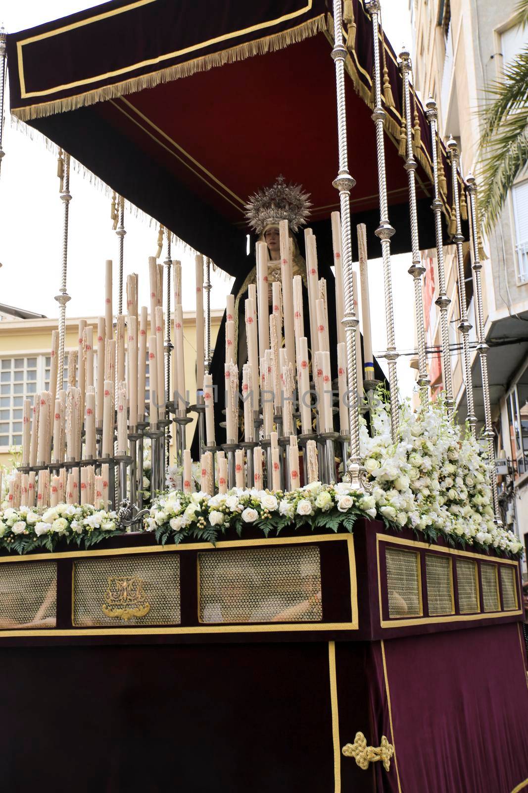 Elche, Spain- April 13, 2022: Virgin Mary on Easter Parade with bearers and penitents through the streets of Elche city in the Holy Week