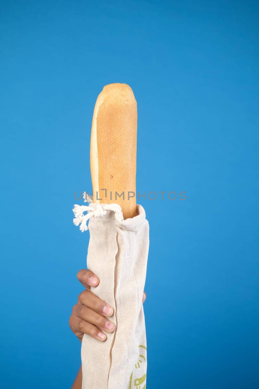 bag with bread on light color background.