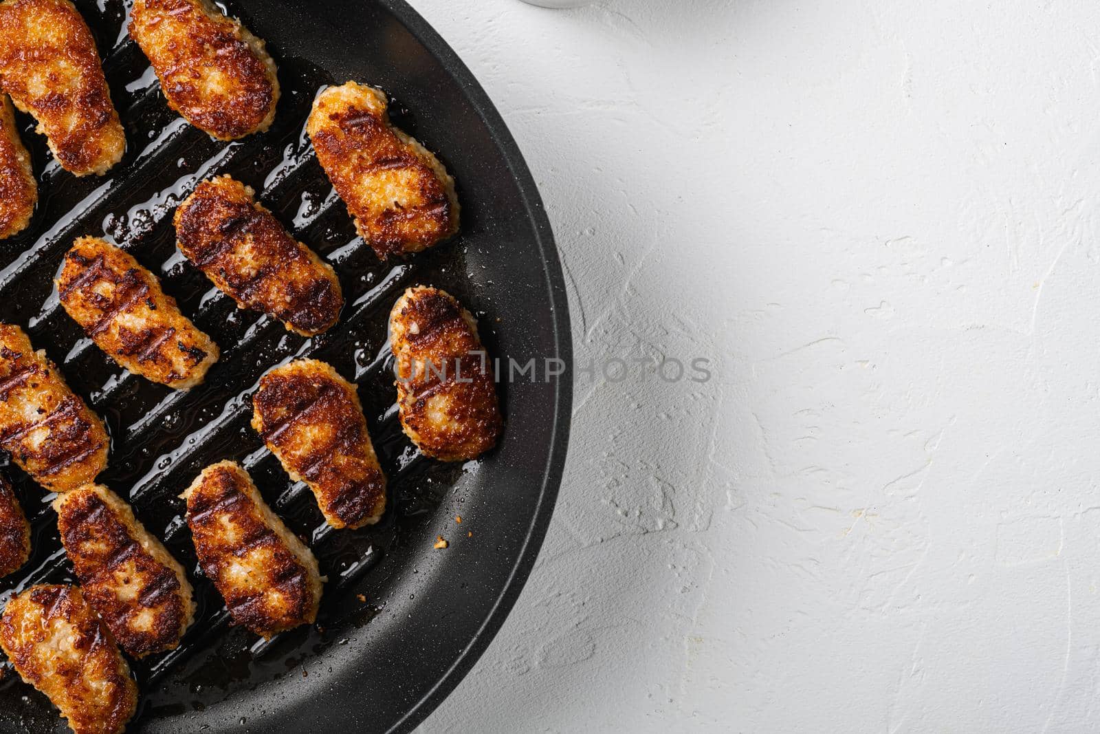 Fried crispy chicken nuggets set, on white stone table background, top view flat lay, with copy space for text