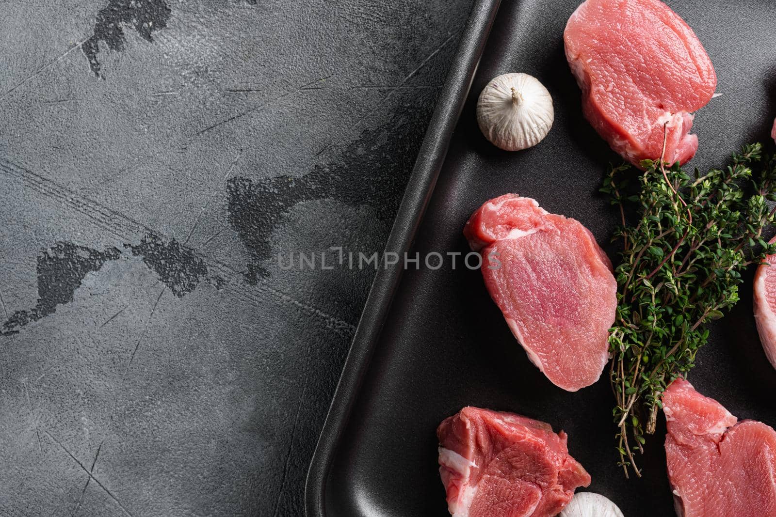 Pork meat fillet, on gray stone table background, top view flat lay, with copy space for text