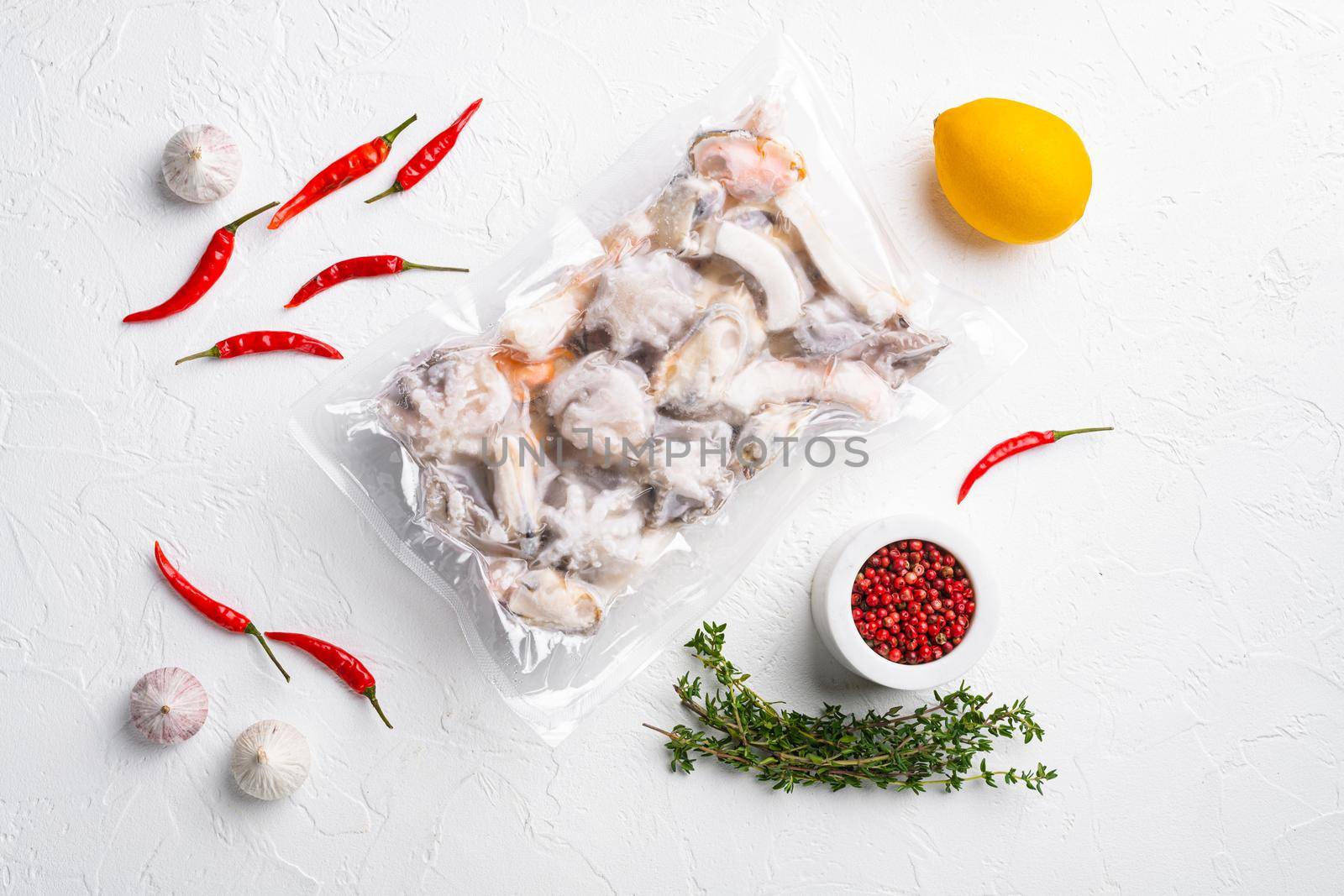 Frozen seafood pack set, on white stone table background, top view flat lay