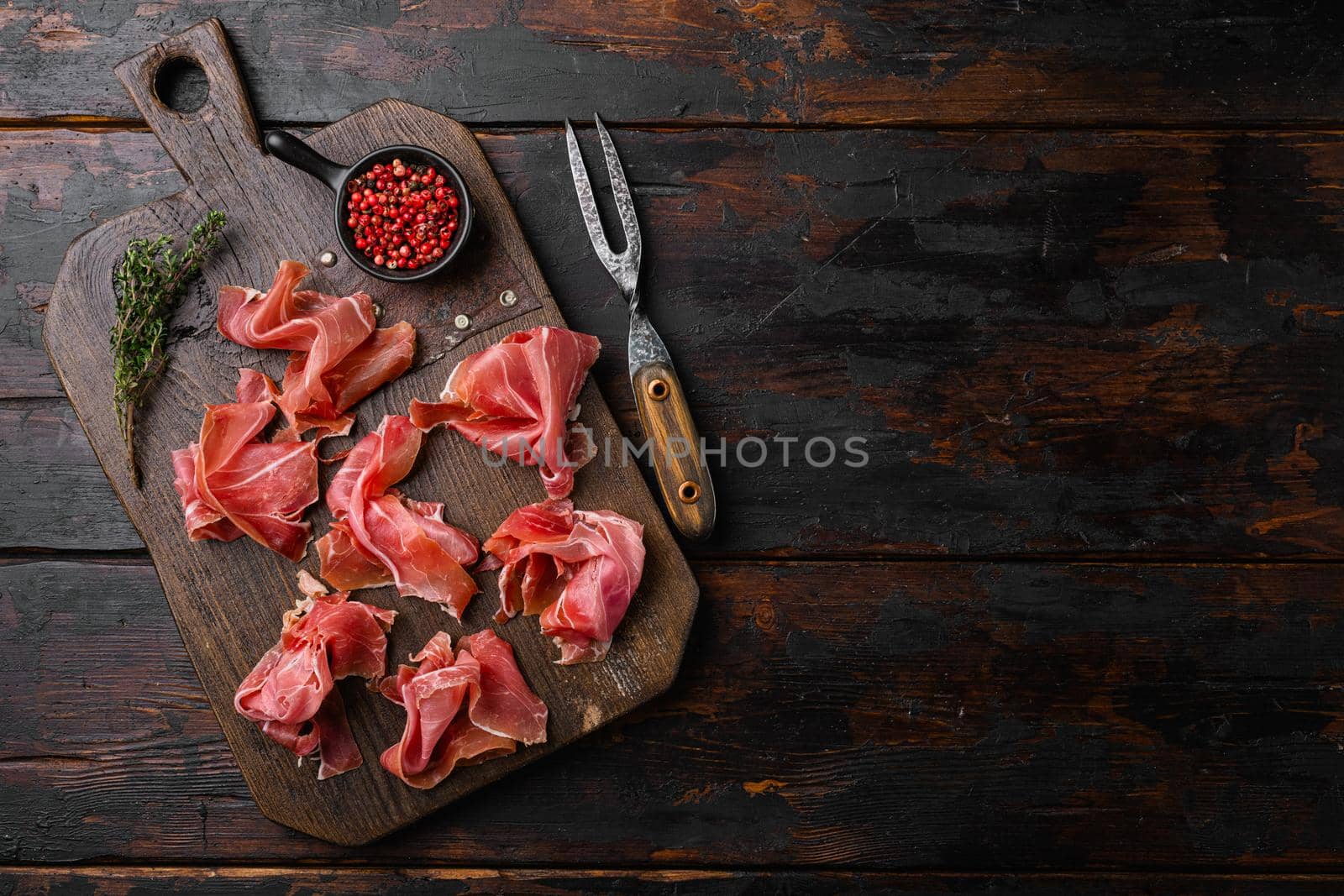 Spanish cold meat jamon set, on old dark wooden table background, top view flat lay, with copy space for text by Ilianesolenyi