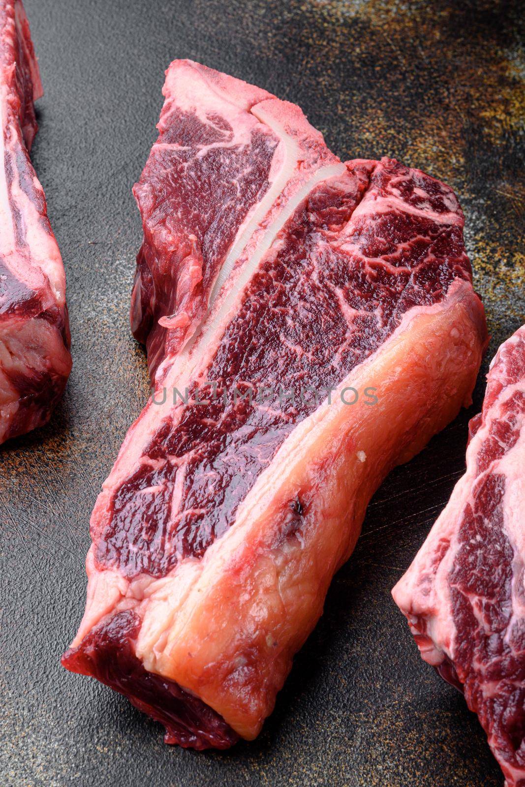 Dry-aged Raw T-bone or porterhouse beef meat Steak set, on old dark rustic background