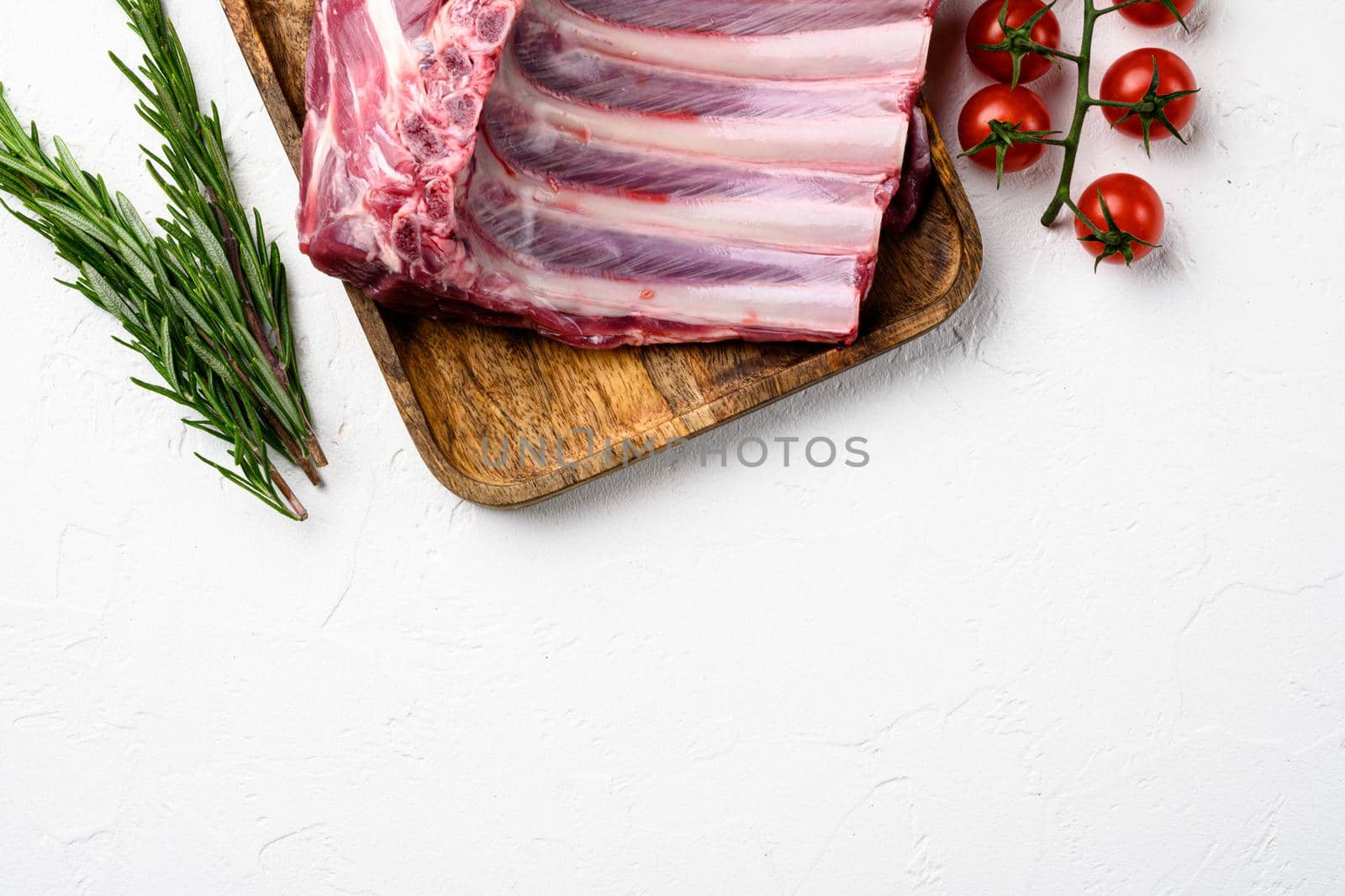 Raw meat rib rack set, on white stone table background, top view flat lay, with copy space for text