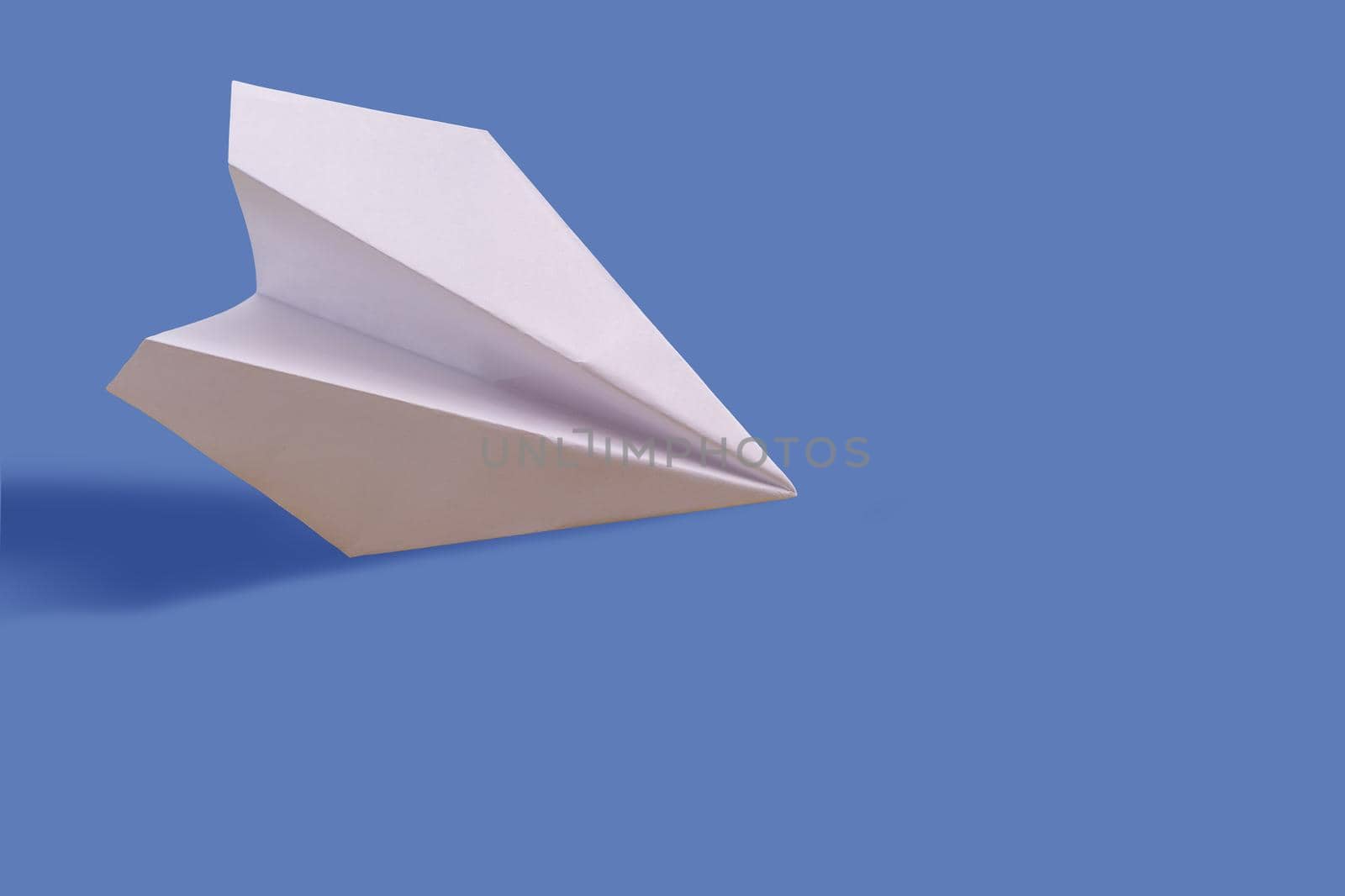 Paper airplane on a blue paper background by Andelov13