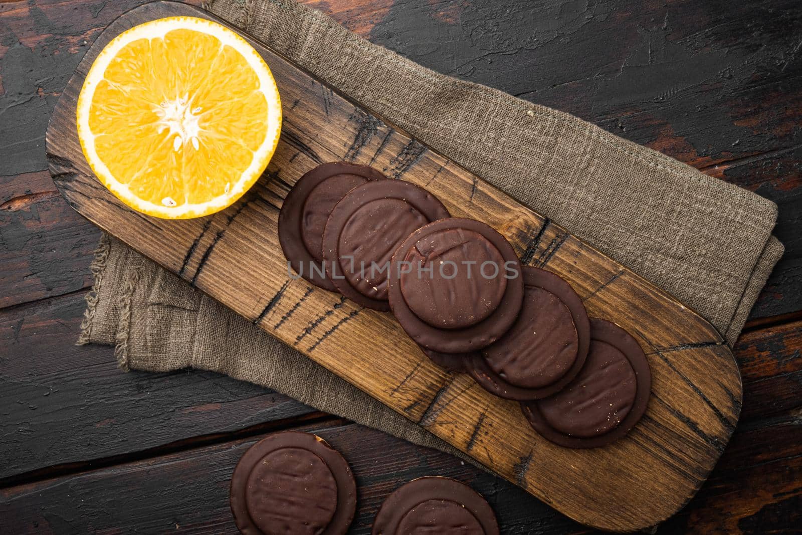 Cakes sweet cookies with orange, chocolate and coffee, on old dark wooden table background, top view flat lay by Ilianesolenyi