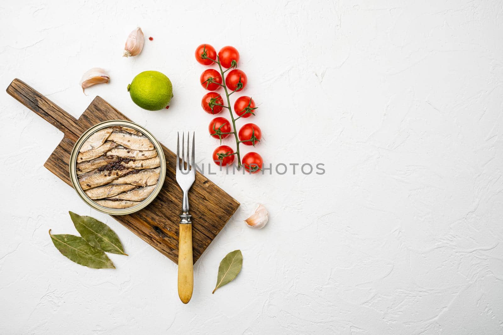Smoked fish with olive oil set, on white stone table background, top view flat lay, with copy space for text