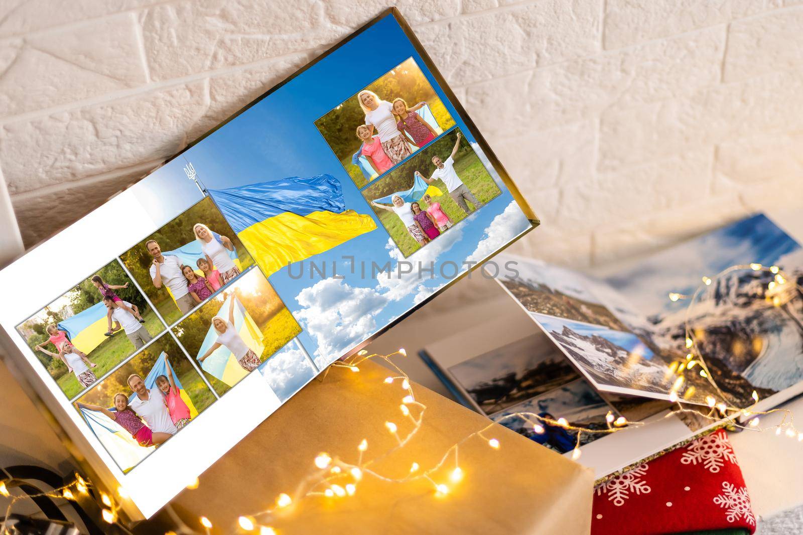 Family photos archive saved in brightly designed photo book; bright summer memories placed in the photobook. family with flag of ukraine.