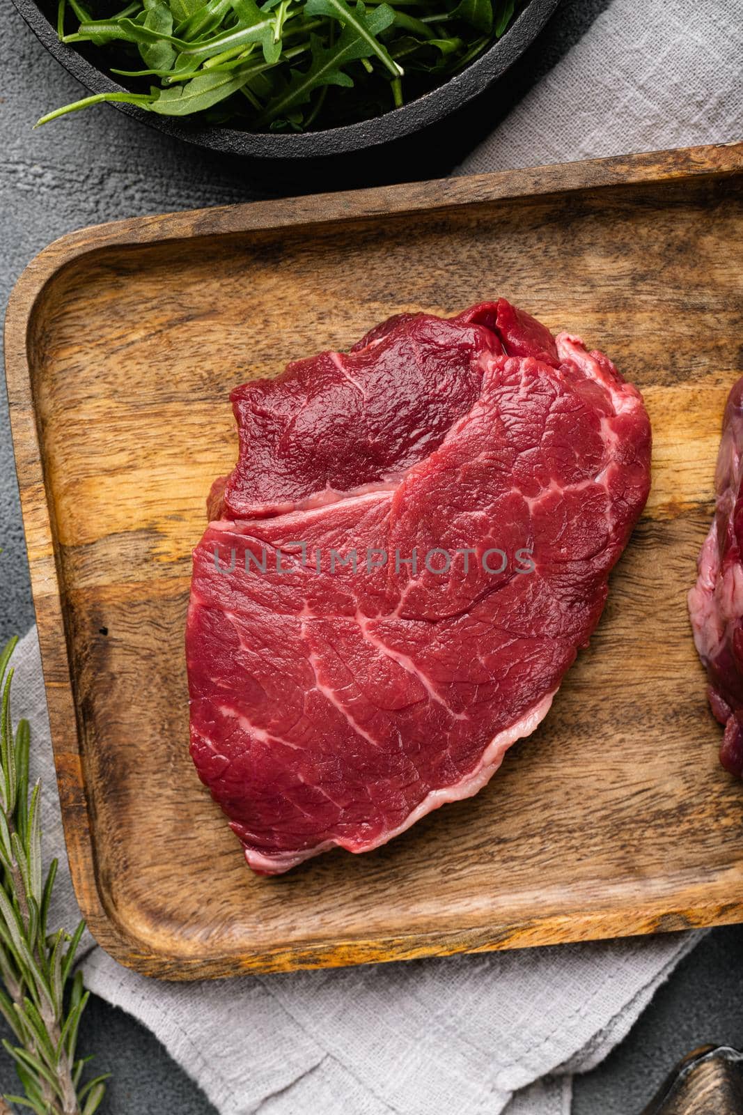 Beef rump meat steak, on gray stone table background, top view flat lay by Ilianesolenyi