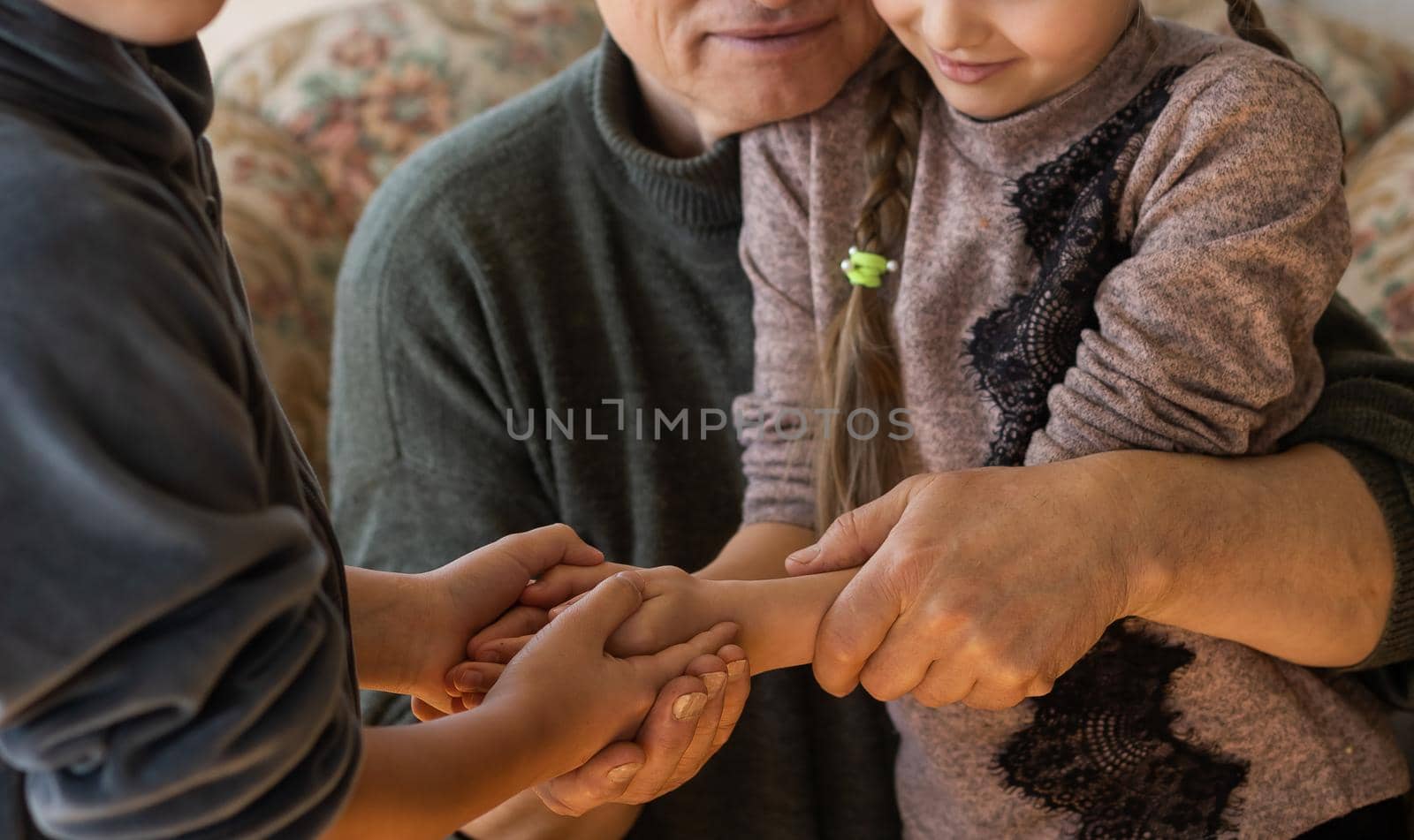 Family bonding. grandfather and child holding hands together, closeup view. Panorama.