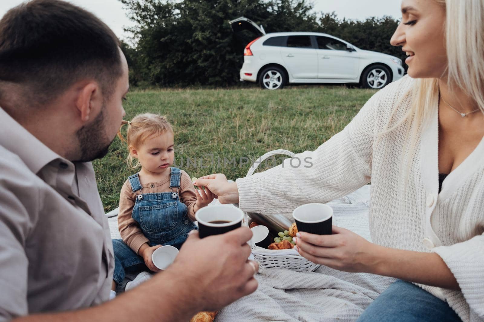 Family Picnic Time, Young Parents with Their Little Daughter Enjoying Weekend Outdoors, Road Trip on SUV Car