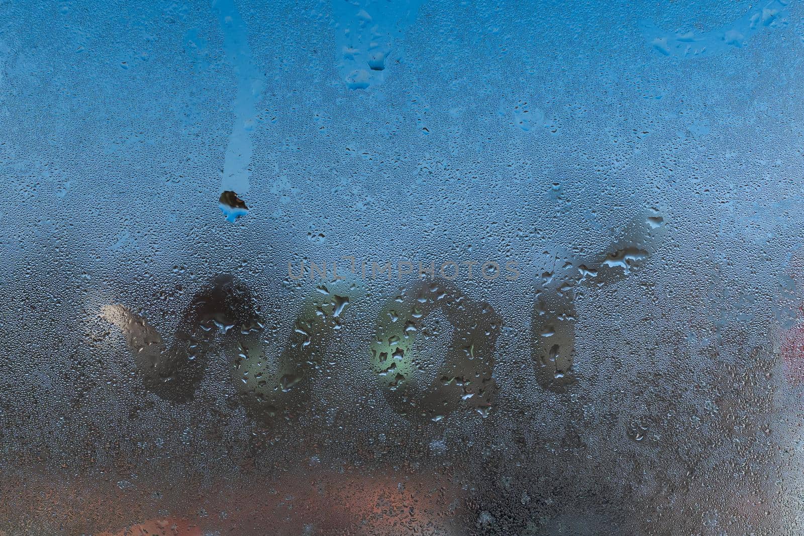 The inscription no war on the misted window glass close up.