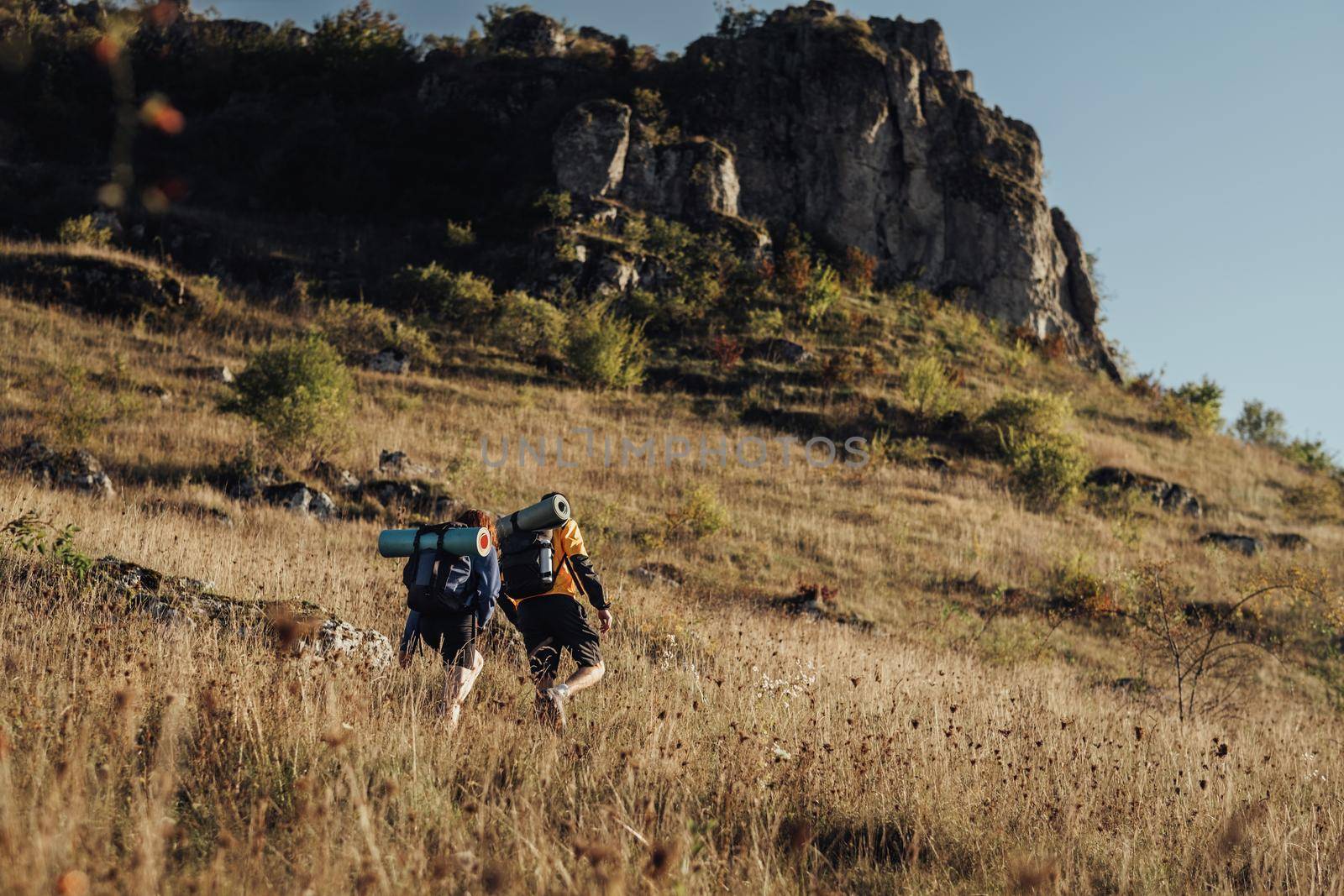 Two Hikers Moving on Their Route on Top of Hill During Sunset, Travel Couple Enjoy Hiking Trip by Romvy