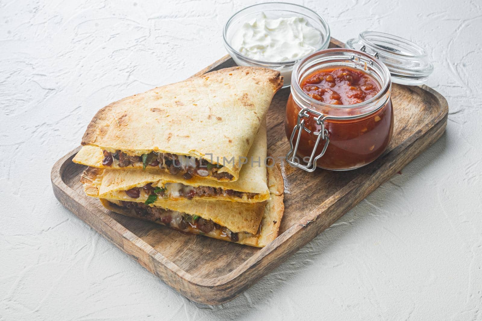 Quesadilla with chicken, cheese and peppers, on white background by Ilianesolenyi