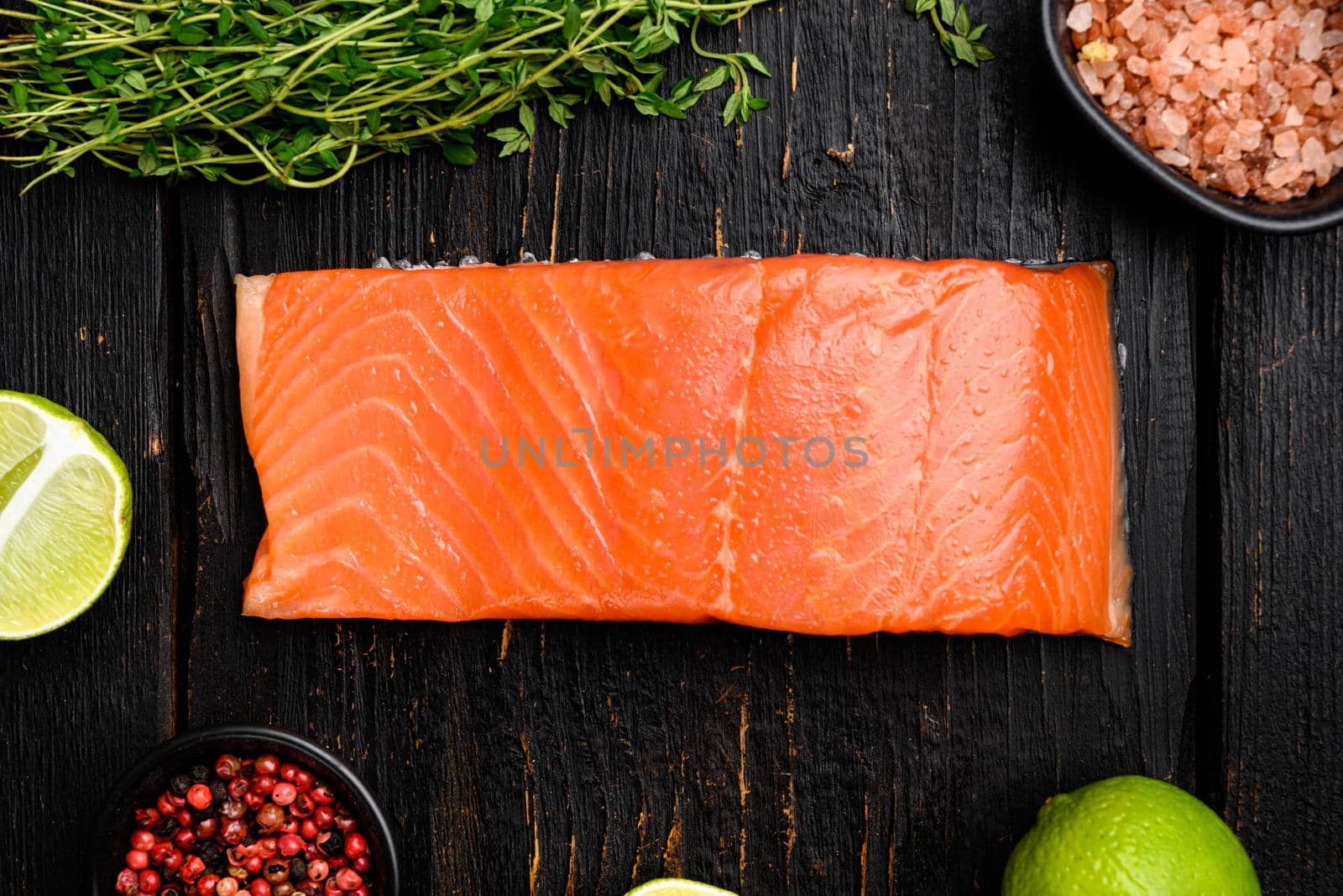 Salmon fillet fish set, with herbs, on black wooden table background, top view flat lay