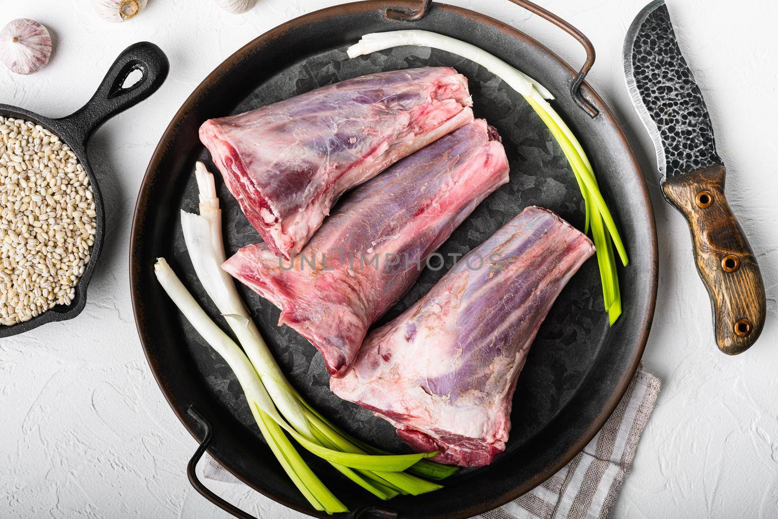 Raw lamb shanks meat, on white stone table background, top view flat lay by Ilianesolenyi