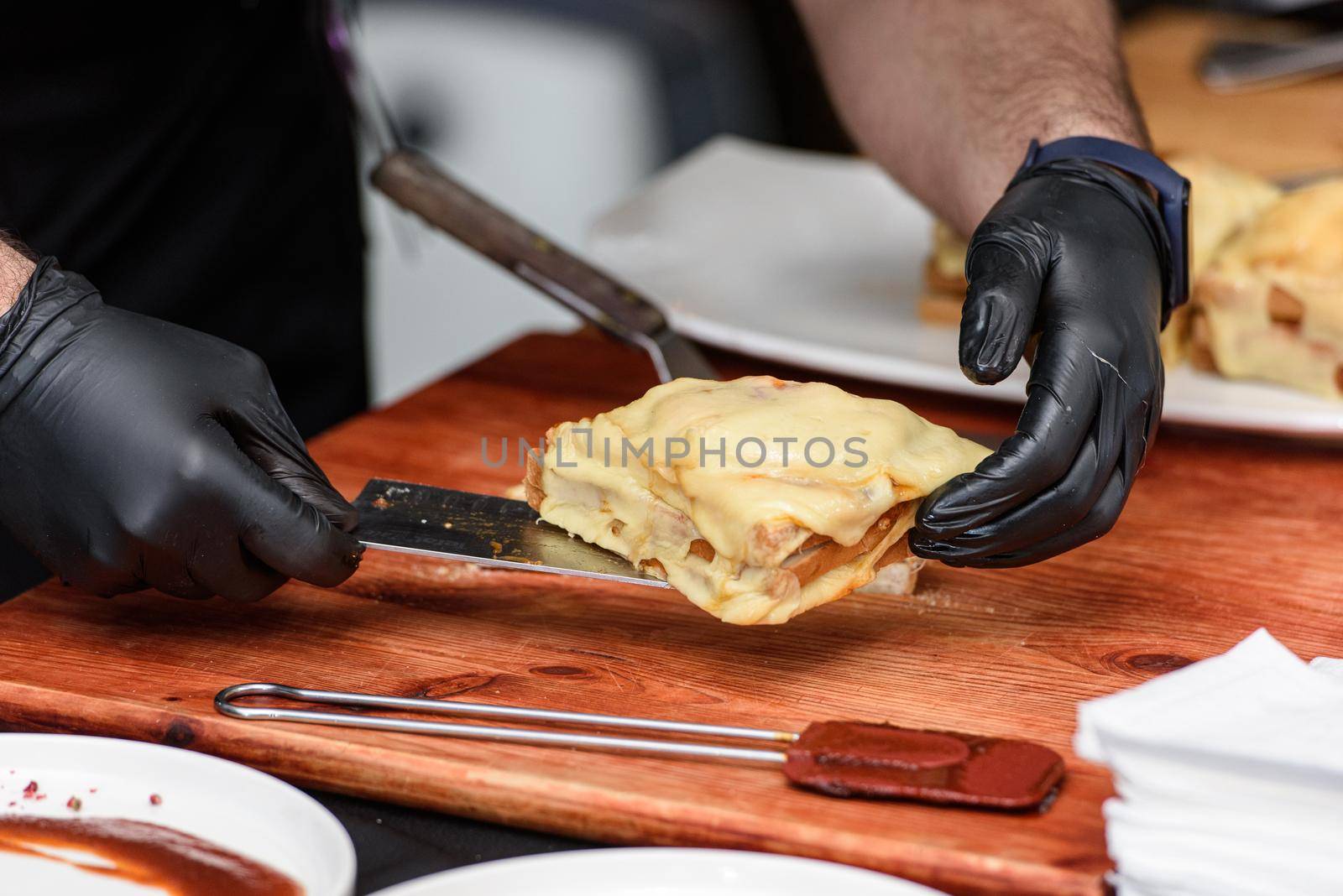 Francesinha, traditional Portuguese sandwich originally from Porto. National cuisine concept. the chef prepares a dish at restaurant.